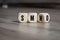 Cubes, dice or blocks with acronym smo Social Media Optimization and smm Social Media Marketing on wooden background