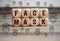 Cubes and dice with corona virus and face mask icons on wooden background