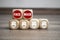 Cubes and dice with corona virus and face mask icons on wooden background