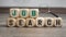 Cubes or dice with magnifier or magnifying glass and job search on wooden background