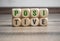 Cubes and dice showing the word positive in green colour on wooden background