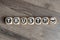 Cubes and dice on wooden background showing the words trust and handshake icon