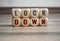 Cubes and dice with word shutdown and lockdown on wooden background