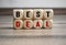 Cubes and dice with words best deal on wooden background