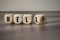 Cubes and dice with the words hell and help on wooden background