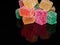 Cubes of jelly on a black reflective background