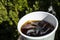 Cubes of large ice from a glass with strong coffee. Alternative Cold Brew coffee drink. Play of color and patches of light.