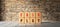 Cubes with the message FAIR PLAY in front of a brick wall on wooden floor