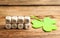 Cubes with phrase GOOD LUCK and clover leaf on table