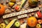 Cubes with phrase THANKSGIVING DAY, autumn fruits and vegetables on wooden table, flat lay