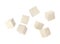 Cubes of raw tofu falling on white background