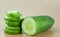 Cucumber half and Slices on wood table background