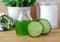 Cucumber juice in a small glass jar for preparing natural facial toner. Homemade cosmetics.