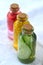 Cucumber, marigold and rose infusions in glass bottles