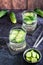 Cucumber mineral water in glasses on the table. Homemade antioxidant drinks. Vertical view