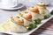 Cucumber rolls with salmon, cream cheese closeup horizontal