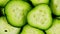 Cucumber, sliced pieces of green cucumber stacked on a hill rotate. Circles of fresh cucumbers as food background.