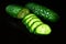 Cucumber sliced rings on a black background