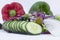 Cucumber slices with olives, onion slices and vegetables with two out of focus bell peppers