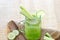 Cucumber smoothie diet, smoothie detox on sack and wooden background