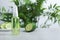 Cucumber tonic in bottle on table against blurred background.