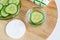 Cucumber water, cucumber slices and cotton pad. Ingredients for preparing homemade eye mask or skin toner. Natural beauty