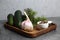 Cucumbers, fennel pepper, a bowl of salt and garlic on white background - home canning concept