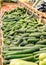 cucumbers and other useful fresh vegetables are on the counter in the supermarket.