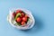 Cucumbers and tomatoes in plastic bag on blue background. Stop using artificial food storage bag