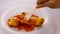 Cucur Udang or Prawn Fritters covered with chilli sauce on isolated white background