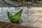 Cuddling couple in swinging hammock dipping into ocean