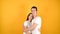 Cuddling young couple  on a yellow background