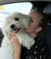 Cuddly hug of a girl and her pet in a car