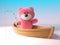 Cuddly pink fluffy teddy bear character is fishing from a dinghy boat, 3d illustration