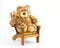 Cuddly teddy bear in a brown wooden chair isolated on white