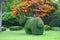 Cuddly topiary rabbit on green lawn in public park in Asia.