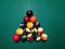 Cue aim billiard snooker pyramid on green table. A Set of snookers/pool balls on Billiards table.