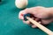 Cue stick with chalk block on green billiard table.Chalk block on pool table