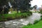 Cuenca, Ecuador - April 22, 2015: Tomebamba river as seen running through Cuenca city, peaceful and green sorroundings