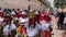 Cuenca, Ecuador, Dec 24, 2021 - Colorful COVID masked people dance in a Christmas parade.