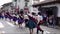 Cuenca, Ecuador, Dec 24, 2021 - COVID masked couples dance away from camera in a Christmas parade.