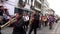 Cuenca, Ecuador, Dec 24, 2021 - Wind instruments play while Masked Devils dance in a Christmas parade.