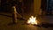 Cuenca, Ecuador - December 31, 2018 - Family stokes street bonfire at midnight on New Years Eve burning Old Year effigy