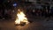 Cuenca, Ecuador - December 31, 2018 - People dance in circle next to street bonfire at midnight on New Years Eve