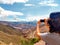 Cuesta Lipan, landscape in the North of Argentina, state of Jujuy. Mountains. Young woman taking a photo of the landscape. Concept