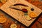 Culinary arts concept. Spices scattered around cutting board. Spoon with spices on wooden texture. Spoon filled with