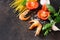 Culinary background for cooking with pasta, shrimps, tomatoes, fresh herbs and spices.