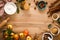 Culinary background. Cooking Thanksgiving autumn apple pie with fresh fruits and walnuts on wooden table