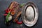 Culinary background with empty metal plate and space for a text. Flat lay composition of chili peppers, rosemary, spices and skewe