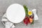Culinary background with empty white cooking board and space for a text, flat lay composition of oil, chili peppers, rosemary, oni